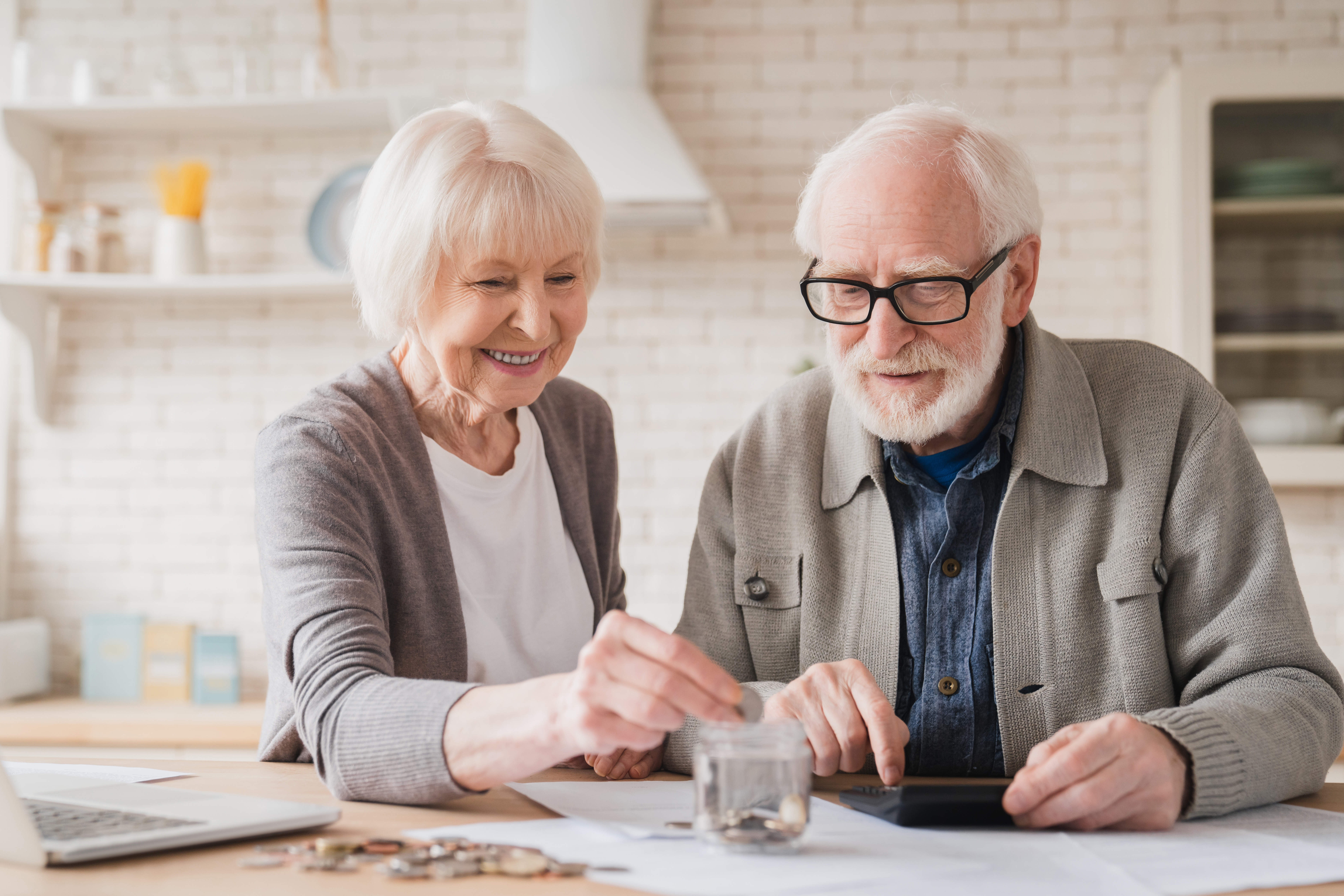 Grandparents putting coin into moneybox, economy for nest egg, pension, mortgage loan at home